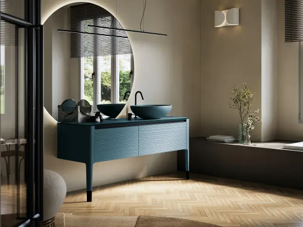 Waschtisch REVERSO 14 durchgehend in tiefem Petrolblau mit gerillter Front und rundem Auflagebecken