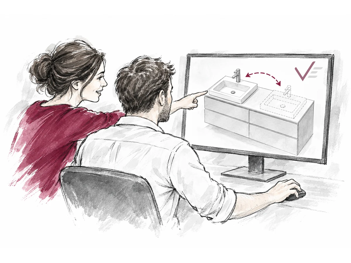 Zwei Personen sitzen an einem Computer und sehen die Planung eines Waschtischs mit Badmöbeln.